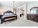 Spacious bedroom suite with sitting area, decorative chandelier, and wooden furniture at 9071 Woodland Forest Rd, Orlando, FL 32836