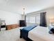 Cozy bedroom with carpet, dresser, and natural light from a window at 9071 Woodland Forest Rd, Orlando, FL 32836