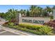 The Phillips Grove community entrance sign, surrounded by tropical landscaping and palm trees at 9071 Woodland Forest Rd, Orlando, FL 32836