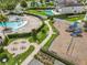 Community pool area featuring a playground, picnic tables, lounge chairs, and recreational pool at 9071 Woodland Forest Rd, Orlando, FL 32836