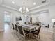 Dining room with hardwood floors, fireplace, stairs, seating for eight and an adjacent living room at 9071 Woodland Forest Rd, Orlando, FL 32836