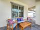 Relaxing front porch seating area with stylish cushions and a view of the home's exterior at 9071 Woodland Forest Rd, Orlando, FL 32836