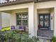 Welcoming front porch with comfortable seating and decorative wreaths on the front door at 9071 Woodland Forest Rd, Orlando, FL 32836