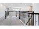 Hallway with decorative wrought iron railing looking out to chandelier in the open concept living area below at 9071 Woodland Forest Rd, Orlando, FL 32836