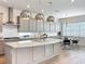 Spacious kitchen featuring granite countertops, stainless steel appliances, custom cabinets and eat-in island at 9071 Woodland Forest Rd, Orlando, FL 32836