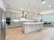 Stylish kitchen with a large island, stainless steel appliances, pendant lighting and hardwood floors at 9071 Woodland Forest Rd, Orlando, FL 32836