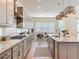 Bright kitchen with stainless steel appliances, spacious island, pendant lights, and a breakfast nook at 9071 Woodland Forest Rd, Orlando, FL 32836