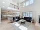 Open-concept living room showcasing high ceilings, staircase, gray cabinets and stainless steel appliances at 9071 Woodland Forest Rd, Orlando, FL 32836