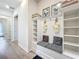 Mudroom with built in bench, storage shelves, decor, and wood flooring at 9071 Woodland Forest Rd, Orlando, FL 32836