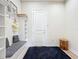 Mudroom featuring a built-in bench with storage, wall decor, and a rug on the hardwood floor at 9071 Woodland Forest Rd, Orlando, FL 32836