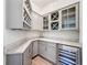 Butler's pantry featuring wine rack, cabinets, stainless steel wine cooler and granite countertops at 9071 Woodland Forest Rd, Orlando, FL 32836