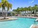 Community pool featuring lounge chairs and lush palm trees, perfect for relaxing and enjoying the Florida sunshine at 9071 Woodland Forest Rd, Orlando, FL 32836