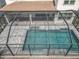 Overhead view of private screened-in pool with patterned tile deck and patio at 9071 Woodland Forest Rd, Orlando, FL 32836