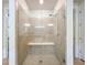 Modern glass-enclosed shower with tile surround and bench at 9071 Woodland Forest Rd, Orlando, FL 32836