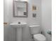 Cozy half-bathroom featuring a pedestal sink and a white toilet at 909 Troon Cir, Davenport, FL 33897
