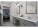 Bathroom with double sinks and entry doorway to bedroom with king bed at 909 Troon Cir, Davenport, FL 33897
