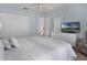 A well-lit bedroom with large closets, neutral walls, and a comfy bed at 909 Troon Cir, Davenport, FL 33897