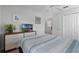 Comfortable bedroom with a dresser and television, featuring a light blue and white bedspread at 909 Troon Cir, Davenport, FL 33897