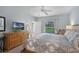 Spacious bedroom with ceiling fan and a window overlooking the landscaped backyard at 909 Troon Cir, Davenport, FL 33897