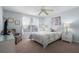 A well-lit bedroom featuring a comfortable bed, nightstand, and a ceiling fan at 909 Troon Cir, Davenport, FL 33897