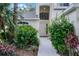 Inviting home entrance with an arched window, elegant door, and lush landscaping at 909 Troon Cir, Davenport, FL 33897