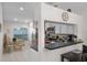 Well-lit kitchen area with modern appliances, stainless steel refrigerator, and dining area with a glass table set at 909 Troon Cir, Davenport, FL 33897