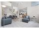 Cozy living room with neutral furniture, tile floors, and a view to the kitchen at 909 Troon Cir, Davenport, FL 33897