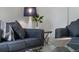 Comfortable living room area featuring stylish furniture, neutral colors, and modern decor at 909 Troon Cir, Davenport, FL 33897