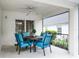 Screened in patio featuring a dining set and view of the backyard at 909 Troon Cir, Davenport, FL 33897
