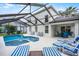 Gorgeous pool area with ample lounging space and covered outdoor seating, perfect for entertaining at 909 Troon Cir, Davenport, FL 33897