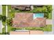 An aerial view of the property with a red tile roof and refreshing private pool at 10067 Mere Pkwy, Orlando, FL 32832