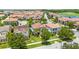 Aerial view of a neighborhood featuring well-maintained homes with tile roofs and mature trees at 10067 Mere Pkwy, Orlando, FL 32832