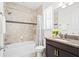 Bathroom featuring tiled shower and tub, granite countertop vanity, and a window for natural light at 10067 Mere Pkwy, Orlando, FL 32832