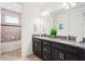 Bathroom featuring dual vanity with granite counters and a separate shower and tub at 10067 Mere Pkwy, Orlando, FL 32832