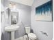 The bathroom boasts a pedestal sink, decorative mirror, and modern fixtures, adding a touch of elegance at 10067 Mere Pkwy, Orlando, FL 32832