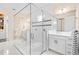 Luxurious bathroom featuring a spacious walk-in glass shower, double vanities, and elegant finishes at 10067 Mere Pkwy, Orlando, FL 32832