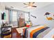 Stylish bedroom with hardwood floors, dinosaur theme, and a mounted television at 10067 Mere Pkwy, Orlando, FL 32832