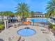 Community pool with a splash pad and lounge chairs, surrounded by lush landscaping and neighborhood homes at 10067 Mere Pkwy, Orlando, FL 32832