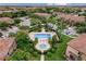 Aerial view of a community pool with fountains, a spa, lush landscaping, and neighborhood homes at 10067 Mere Pkwy, Orlando, FL 32832