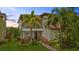 Charming two-story home featuring a cozy balcony and lush, tropical landscaping at 10067 Mere Pkwy, Orlando, FL 32832