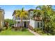 Charming two-story home featuring a cozy balcony and lush, tropical landscaping at 10067 Mere Pkwy, Orlando, FL 32832