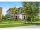 Charming two-story home featuring a cozy balcony and lush, tropical landscaping at 10067 Mere Pkwy, Orlando, FL 32832