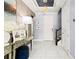 Bright foyer boasts tile flooring, a stylish mirrored console table, and decorative lighting fixtures at 10067 Mere Pkwy, Orlando, FL 32832