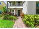 Inviting front entrance with brick pathway, lush plants, and a cozy seating area at 10067 Mere Pkwy, Orlando, FL 32832