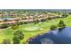 Scenic aerial view of a golf course with a serene lake at 10067 Mere Pkwy, Orlando, FL 32832