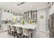 Bright kitchen boasts a spacious island with seating and modern stainless steel appliances at 10067 Mere Pkwy, Orlando, FL 32832