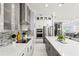 Sleek, modern kitchen with stainless steel appliances, gray island, and ample counter space at 10067 Mere Pkwy, Orlando, FL 32832