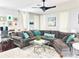 Inviting living room features a comfortable sectional sofa, stylish decor, and plenty of natural light at 10067 Mere Pkwy, Orlando, FL 32832