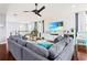 Spacious living room features hardwood floors, a large sectional sofa, and a modern entertainment center at 10067 Mere Pkwy, Orlando, FL 32832