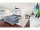 Spacious living room with hardwood floors, a large sectional sofa, and ample natural light at 10067 Mere Pkwy, Orlando, FL 32832